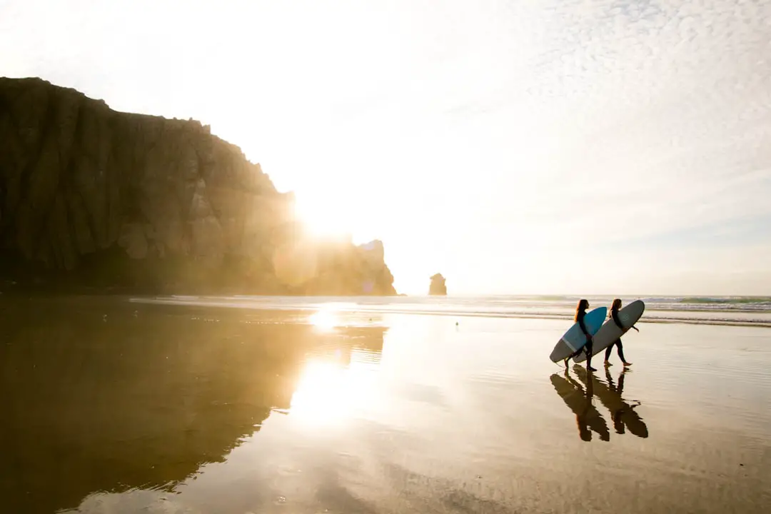 Shot at Morro Bay after a really messy session. Once we got out I realized how beautiful the place looks at low tide. by Hydrofoiling two people carrying surfboards while walking on seashore