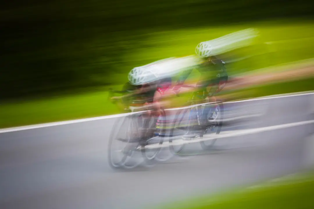 motion photography of two men riding mountain bikes
