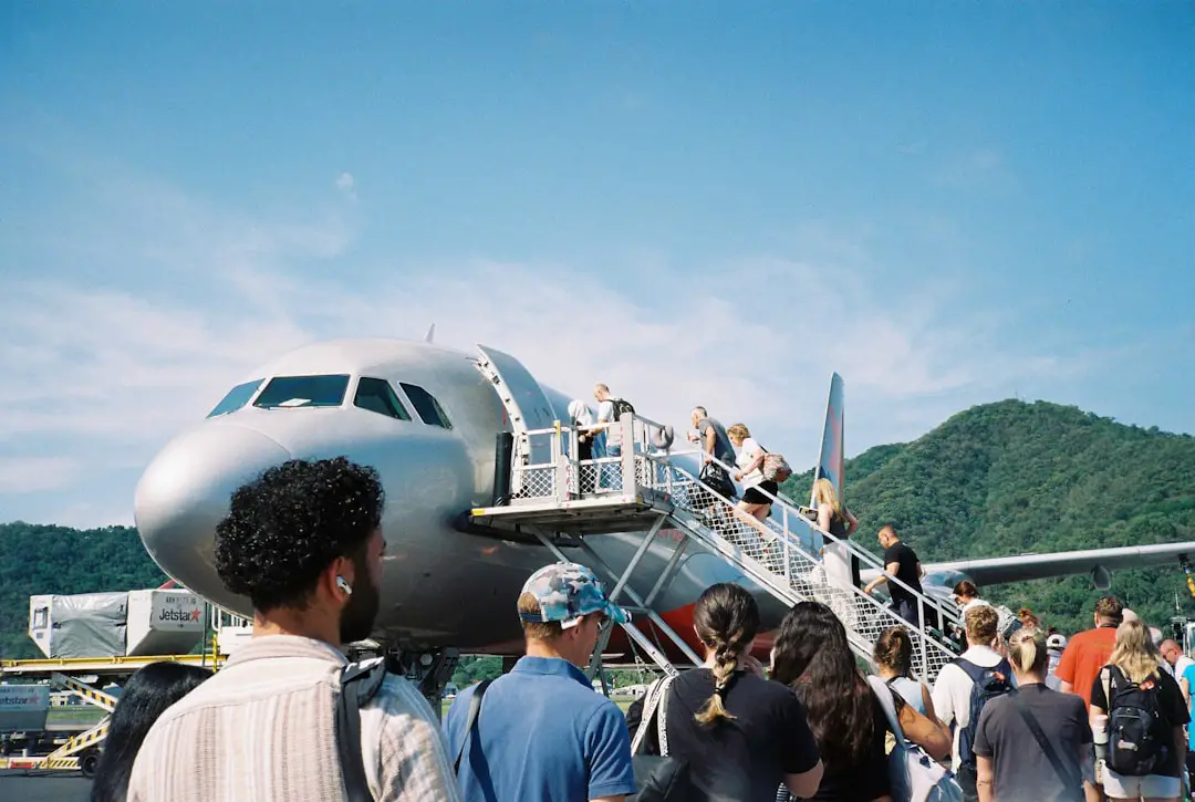 A group of people standing around a plane