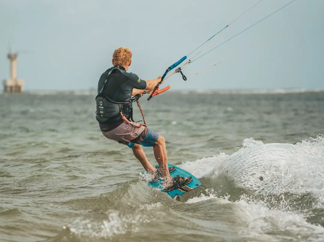 a man riding a surfboard on top of a wave