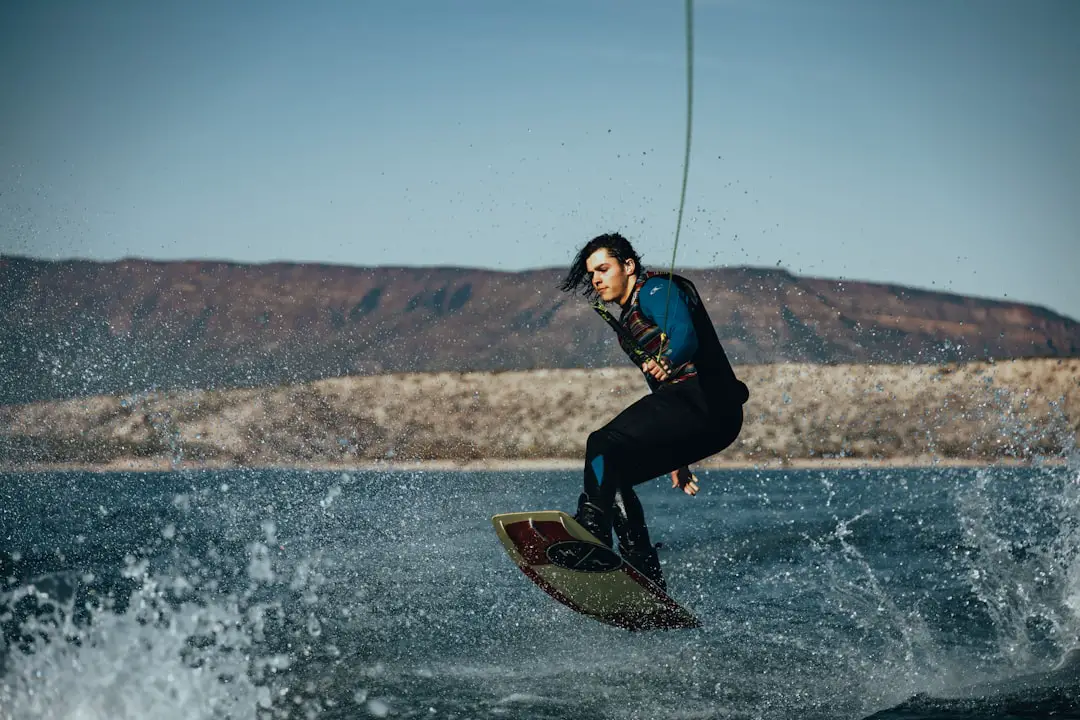 a man riding a surfboard on top of a wave