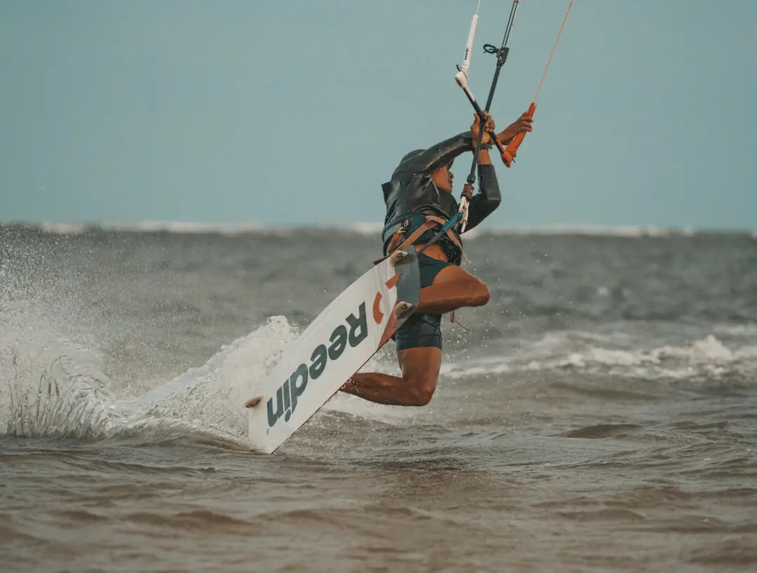 a man riding a surfboard on top of a wave in the ocean
