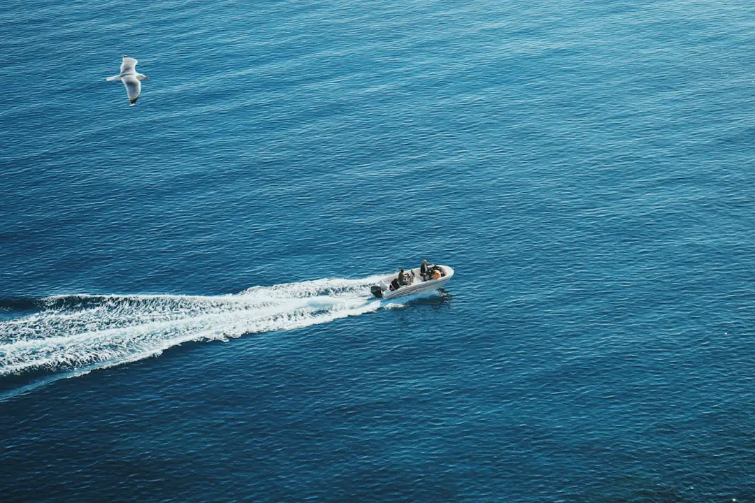 A small boat traveling across a large body of water