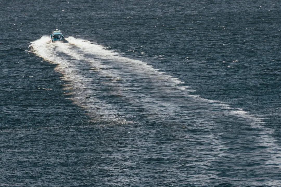 A speed boat is speeding across the water