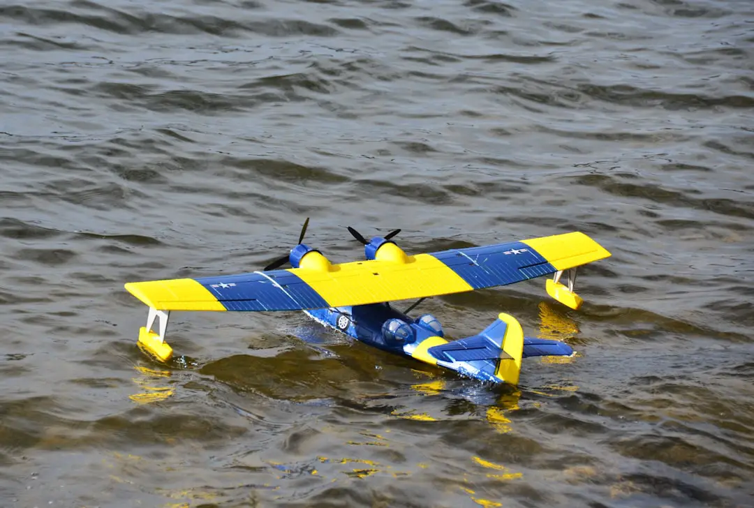 a yellow and blue plane floating on top of a body of water